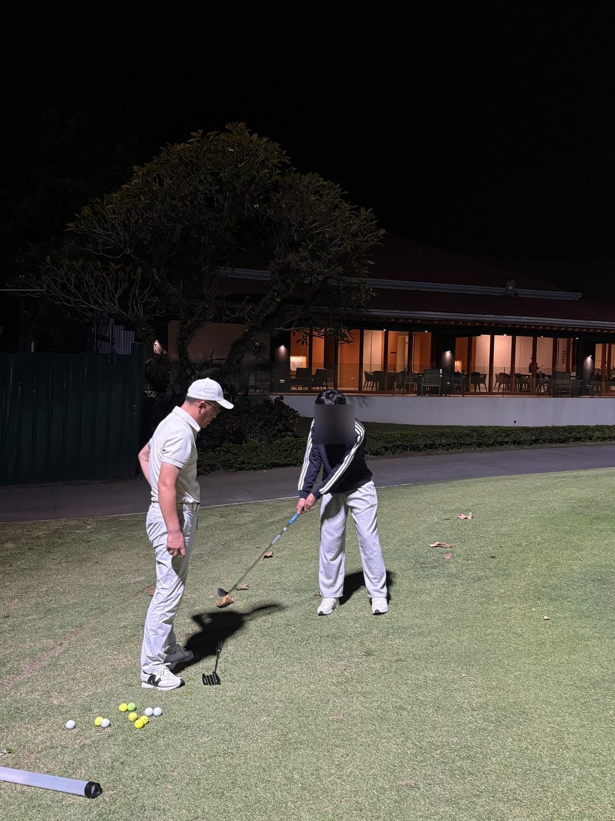 Chip-shot lesson with the teaching pro beside the green