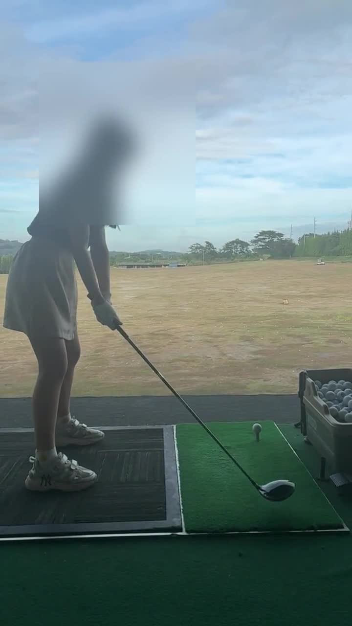 Student working on swing form at the practice range