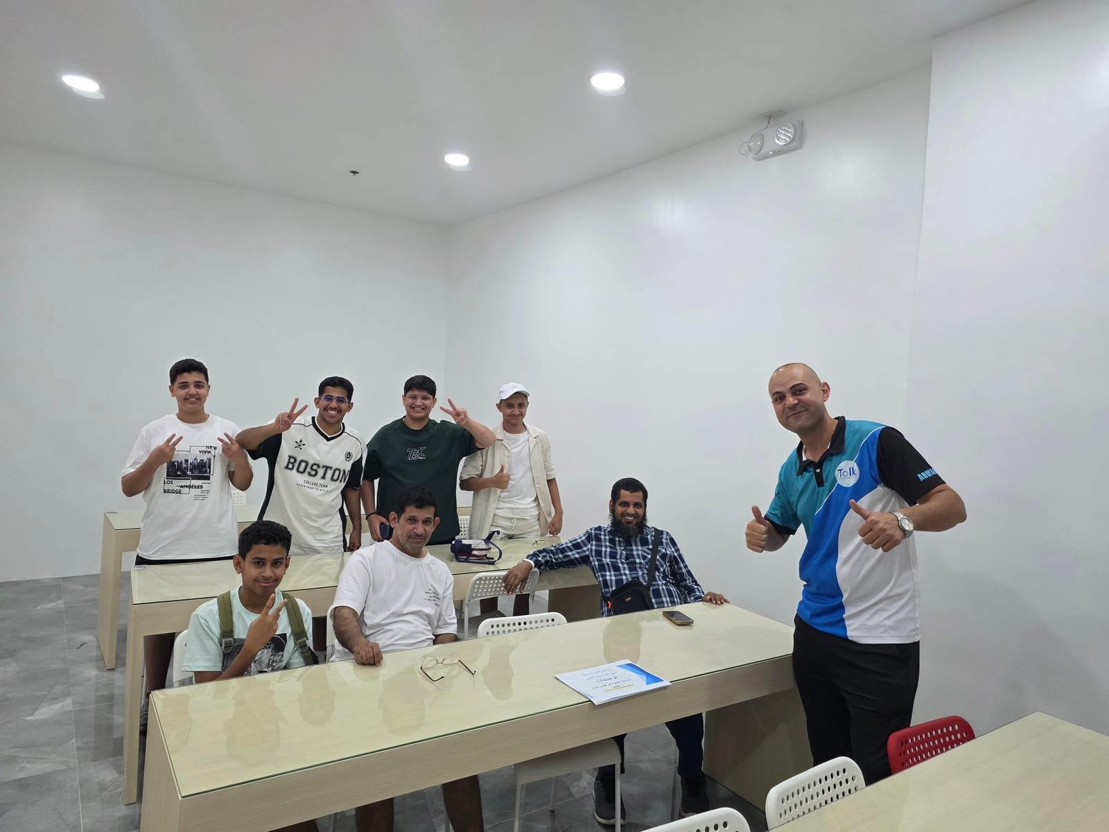 Taiyo with classmates from Saudi Arabia and the Middle East, and a teacher, in the classroom
