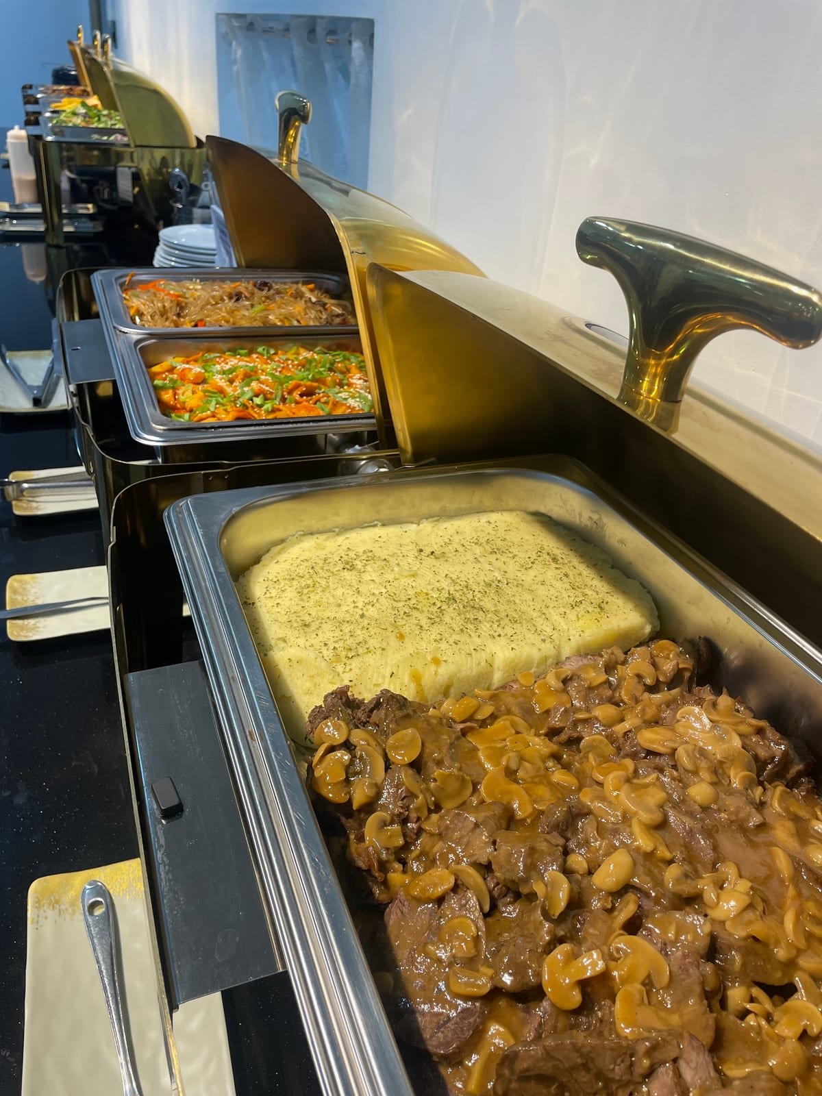 Curries and stir-fried dishes laid out on the canteen serving counter