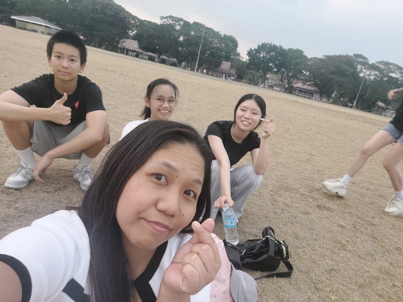 Yuna with classmates on the field at dusk